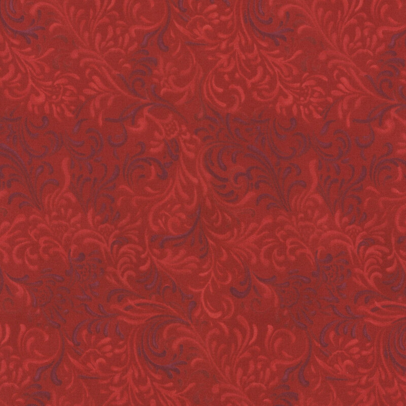 Red fabric with intricate scroll and floral patterns in a tonal design.