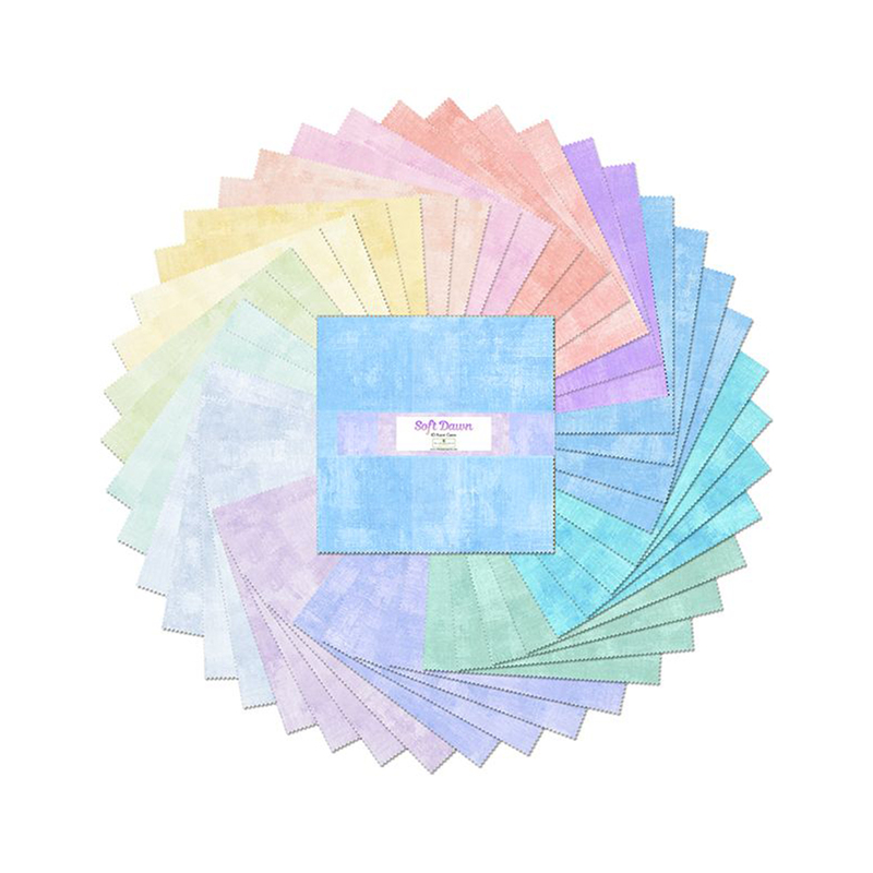 A circular arrangement of colorful textured paper sheets with a central square of blue paper.