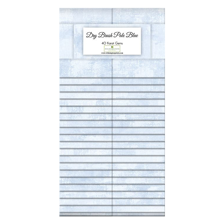 A stacked display of light blue fabrics labeled Dry Brush Pale Blue