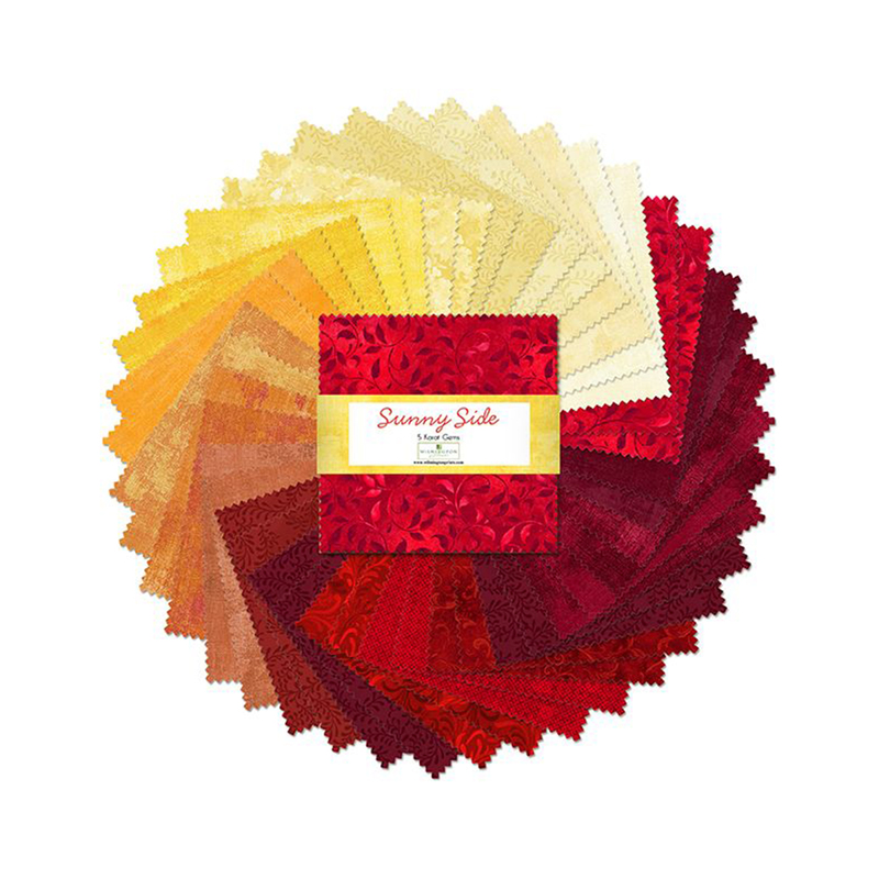 A fanned out collage of the warm red, orange, and yellow fabrics included in the Sunny Side 5 Karat Gems set.