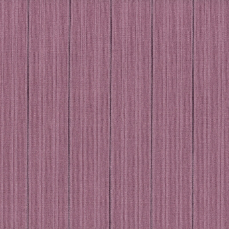 Fabric with vertical stripes in varying shades of purple.
