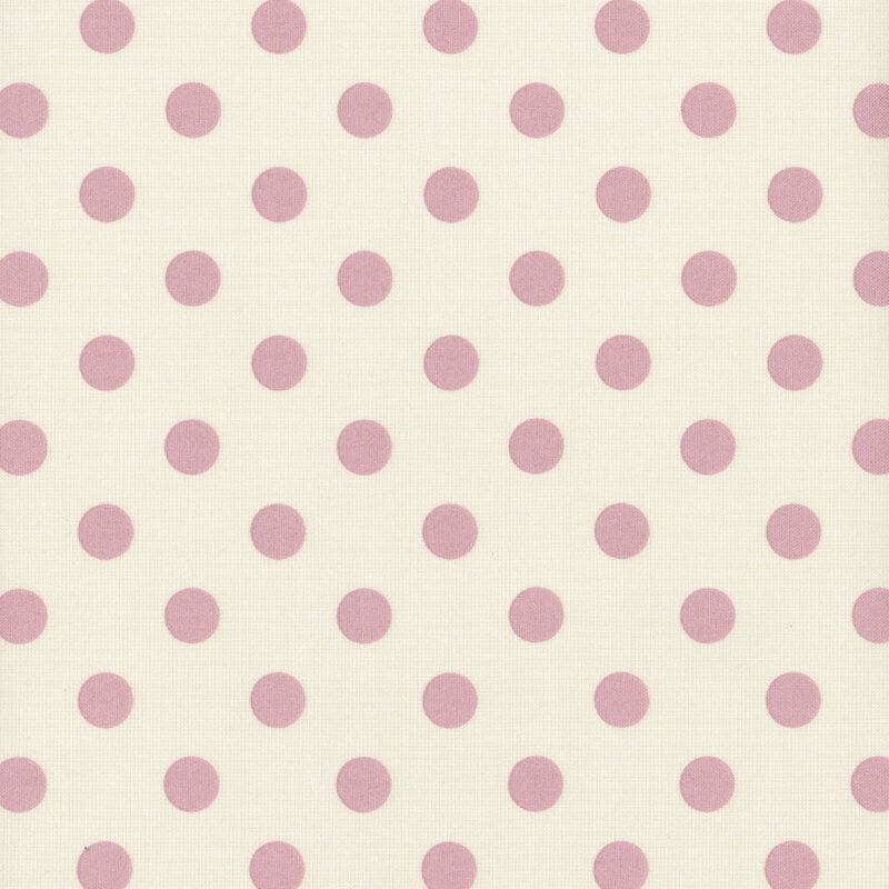 Light cream fabric with evenly spaced pink polka dots.