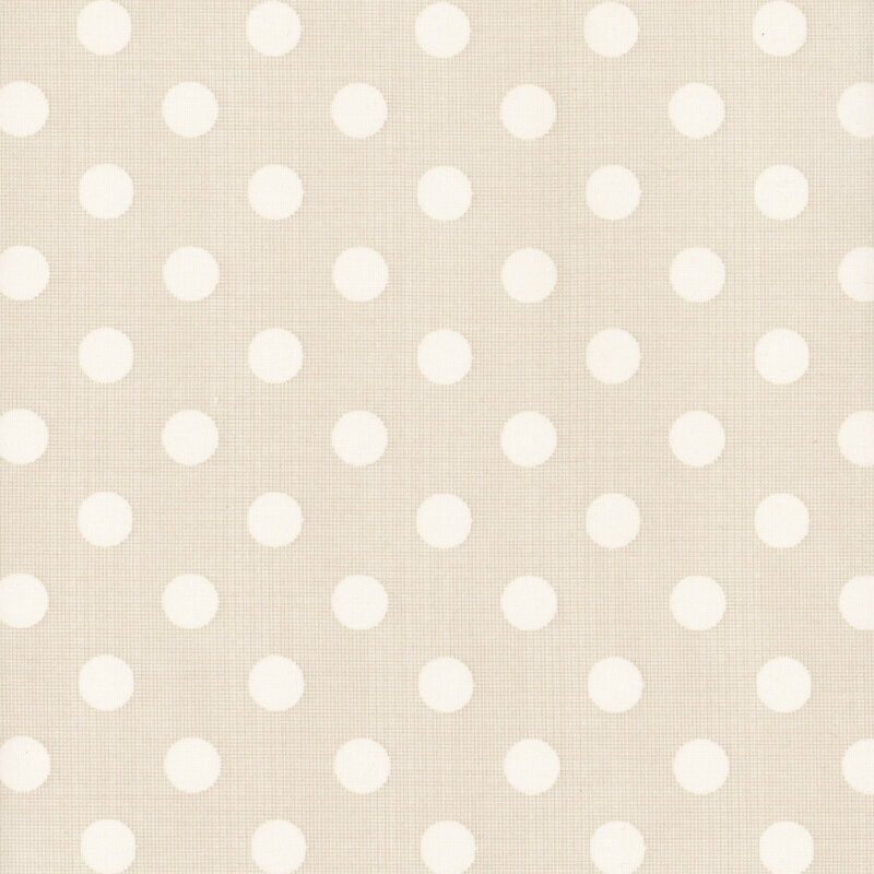 Beige fabric with evenly spaced cream polka dots. 