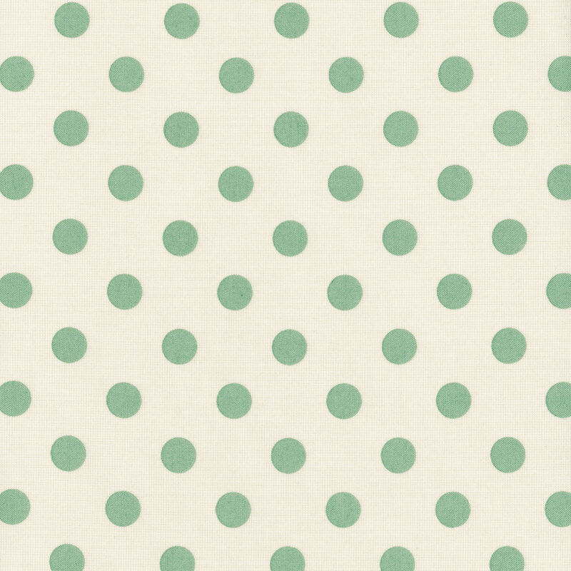 Light cream fabric with evenly spaced mint green polka dots.