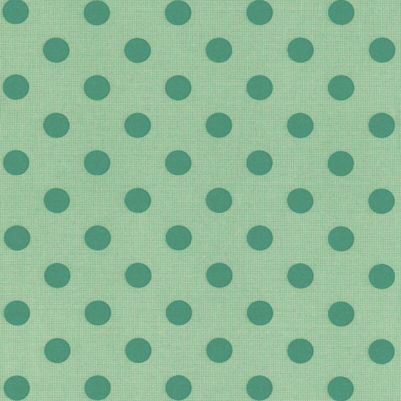 Pattern of tonal circles on a sage green fabric.
