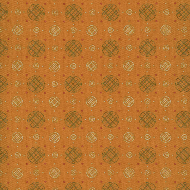 Dark gold fabric with a uniform arrangement of plaid circles and polka dots. 