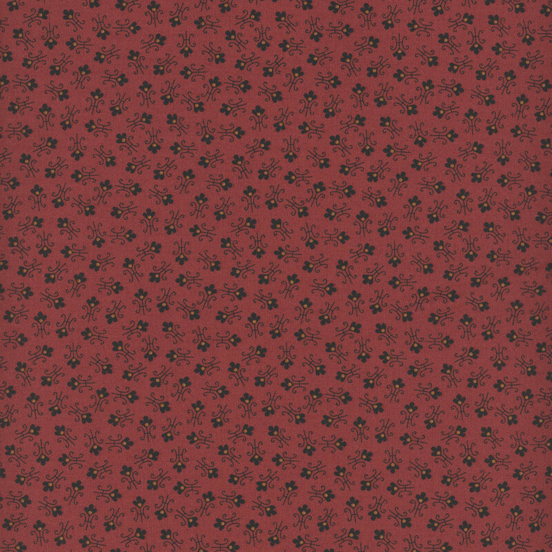 Red fabric with tossed abstract floral shapes.