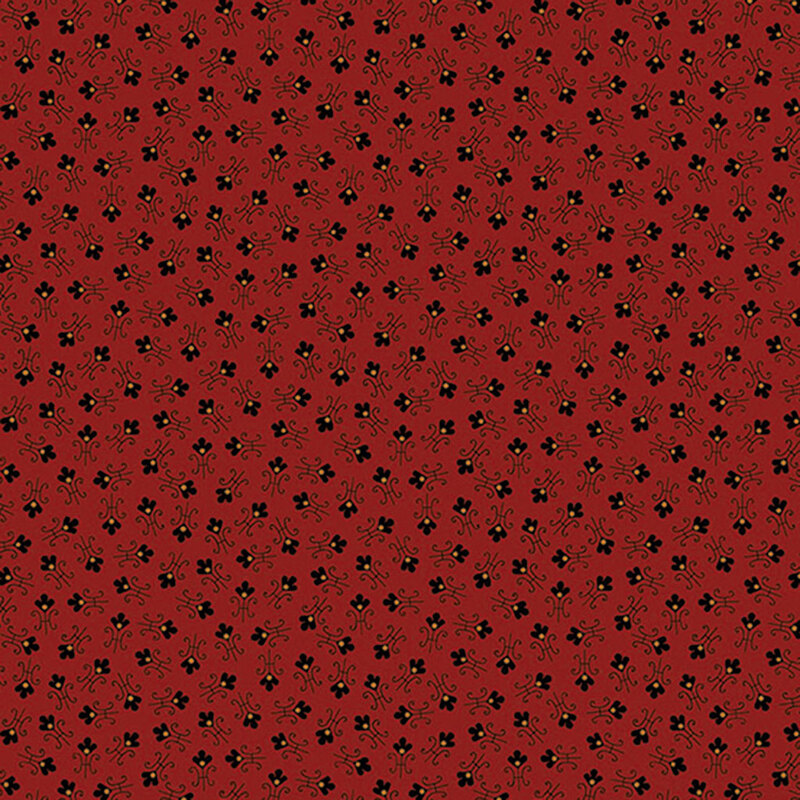 Red fabric with tossed abstract floral shapes.