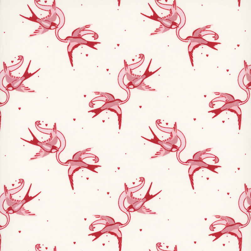 Cream fabric with rotating couples of swallows holding a ribbon between them.