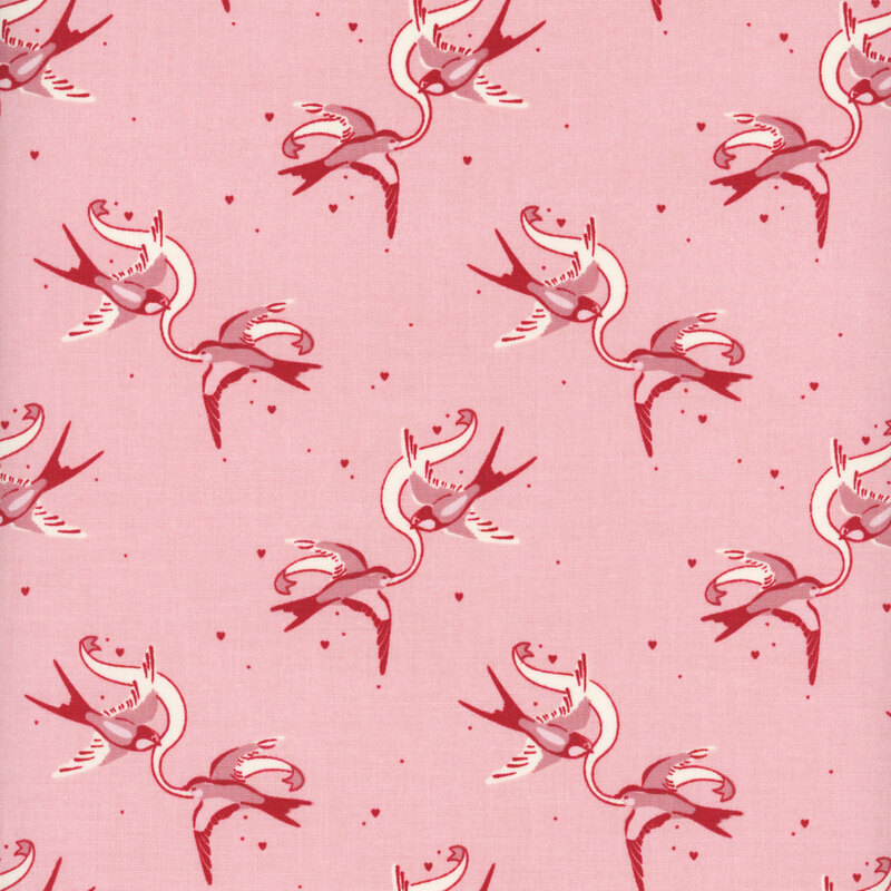 Pink fabric with rotating couples of swallows holding a ribbon between them.