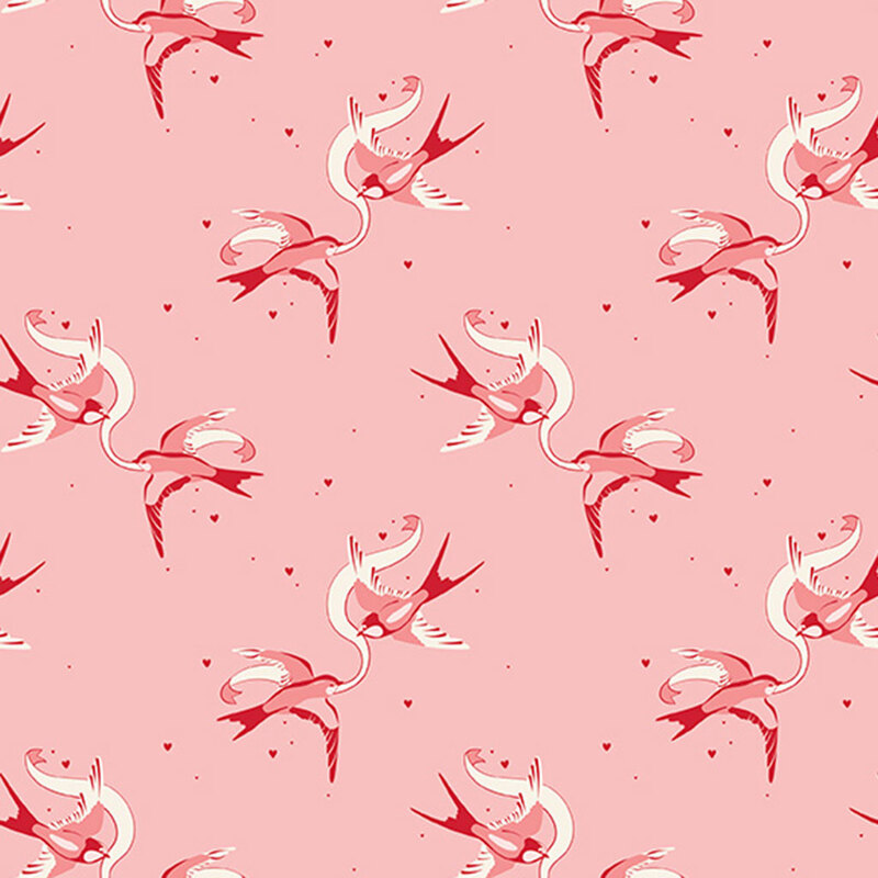 Pink fabric with rotating couples of swallows holding a ribbon between them.