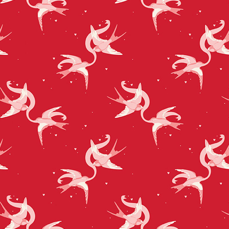 Red fabric with rotating couples of swallows holding a ribbon between them.