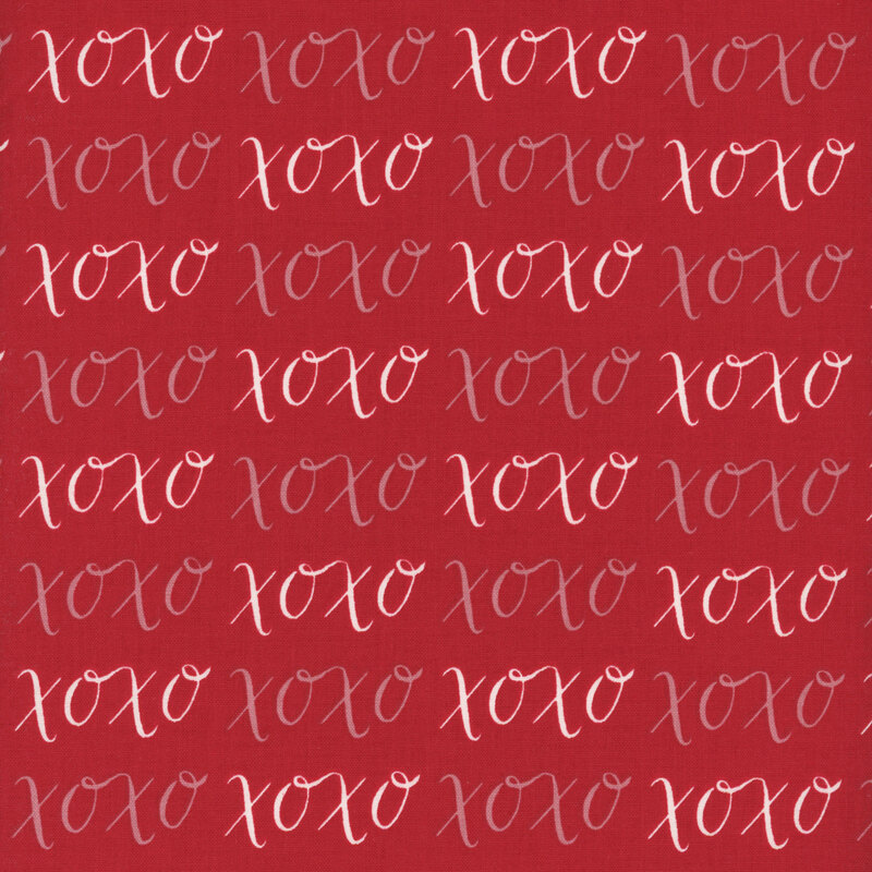 Red fabric with pink and white XOXO's.