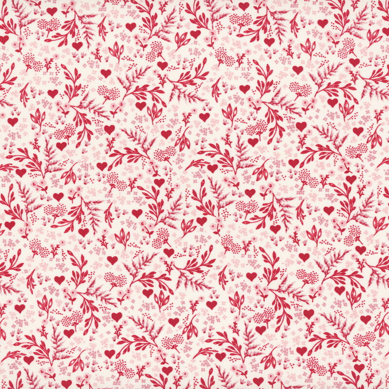 White fabric with a busy design of hearts, flowers, and ferns.
