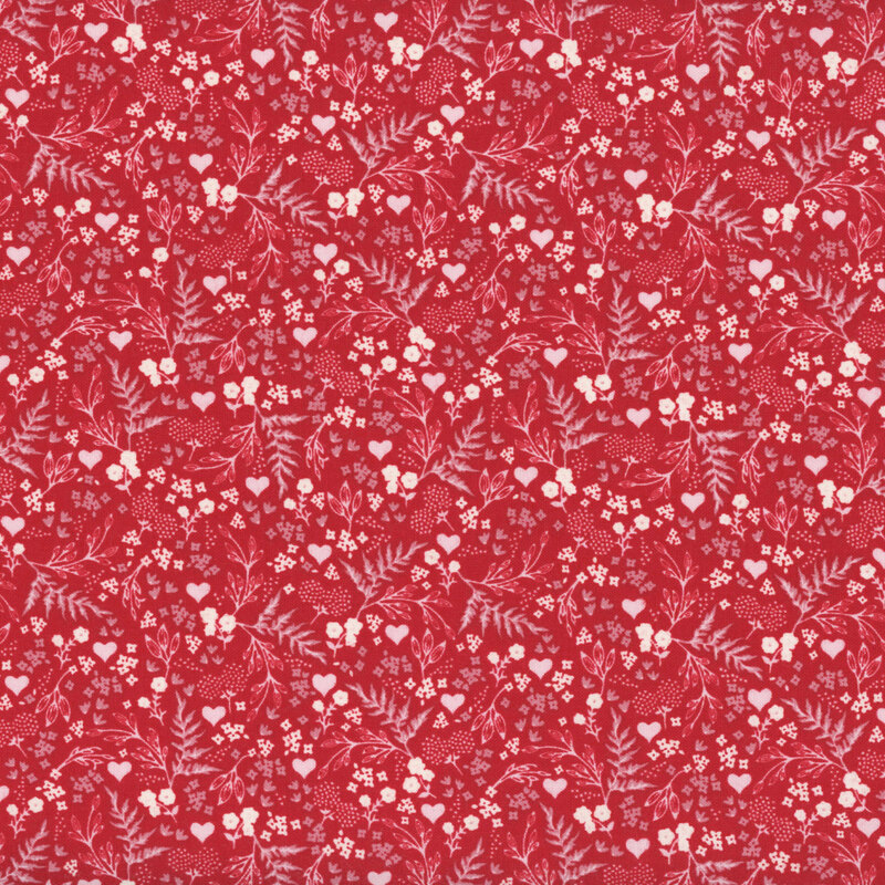 Red fabric with a busy design of hearts, flowers, and ferns.