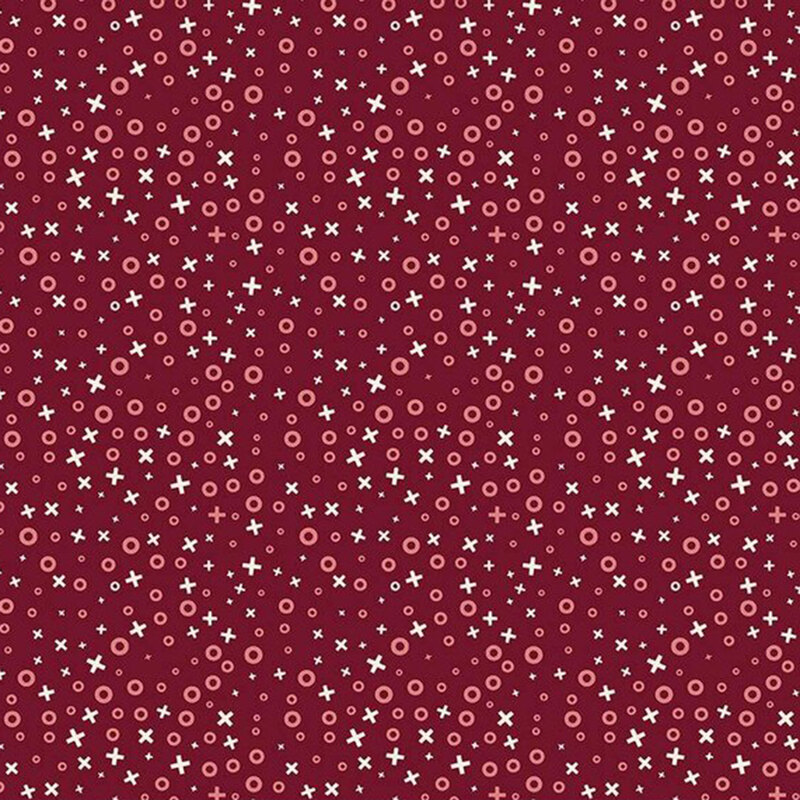 Red fabric pattern with various sizes of circles and crosses in pastel colors.