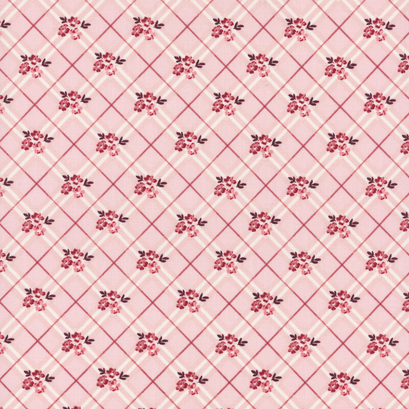 Light pink fabric with a diagonal grid pattern, featuring small red flowers.