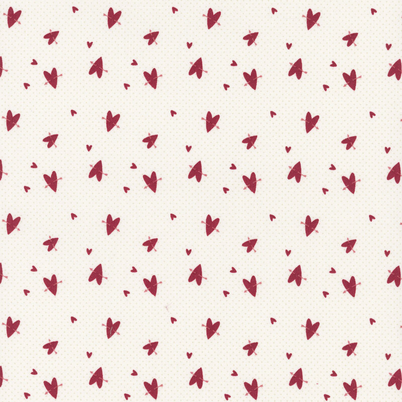 Pattern of small red hearts scattered on a light beige fabric.