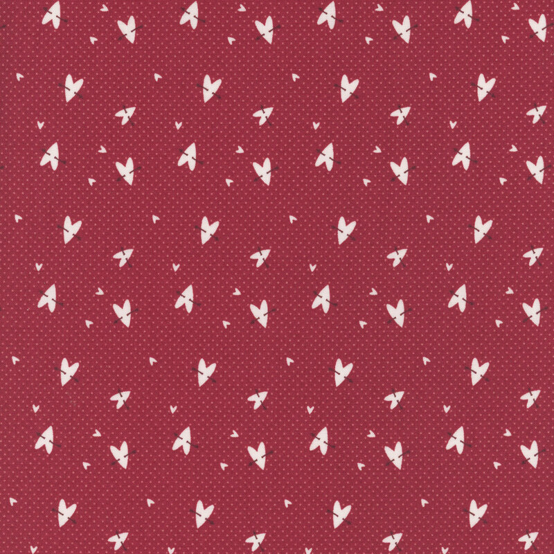 Red fabric pattern with small white heart shapes scattered evenly across the surface.