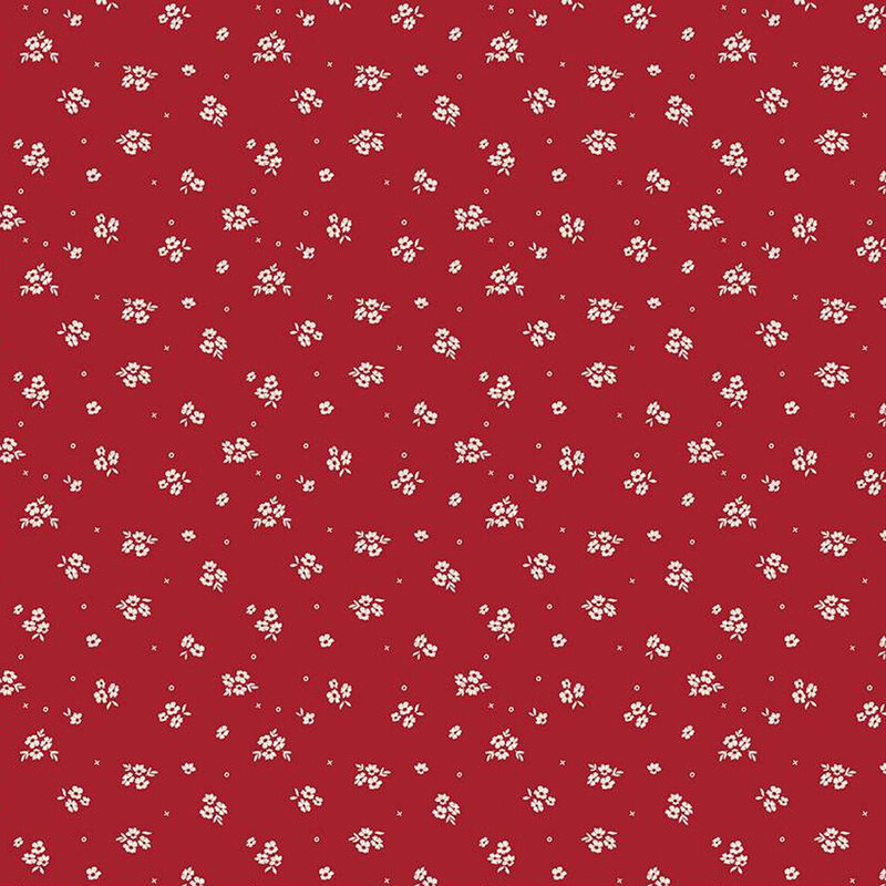 Red fabric pattern featuring small white floral designs scattered evenly throughout.