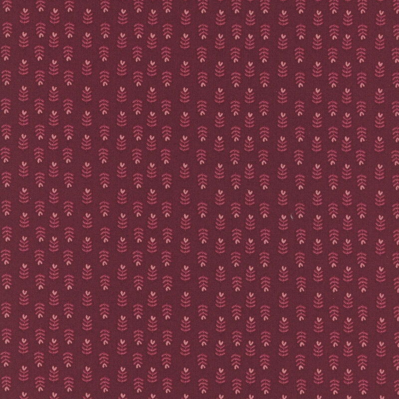 Red fabric with a repetitive pattern of small, intricate designs in a slightly lighter shade.