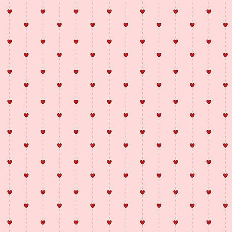 fabric pattern of hearts over a pink background