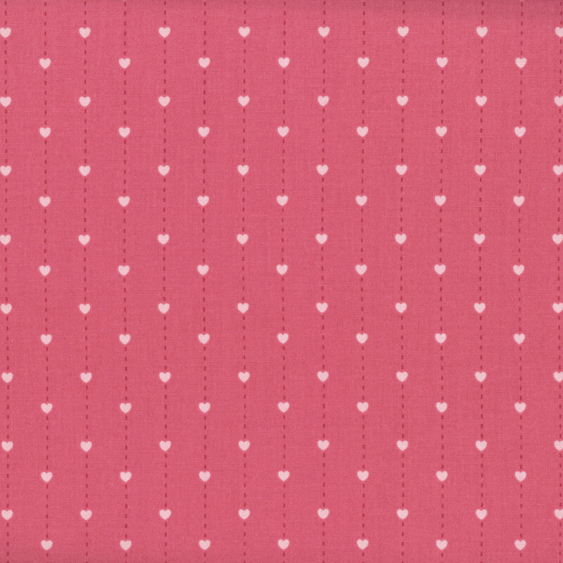 fabric pattern of pink hearts over a deep pink background