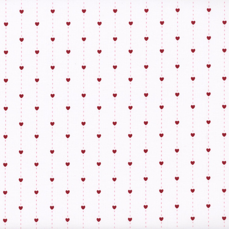fabric pattern of red hearts over a white background