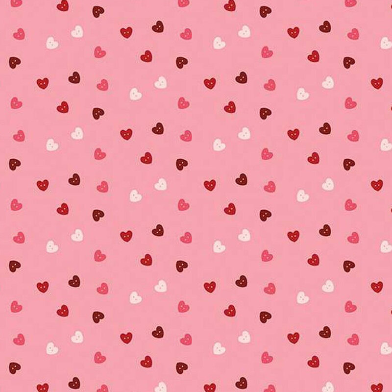 fabric pattern of pink, red, and white hearts scattered all over a light pink background