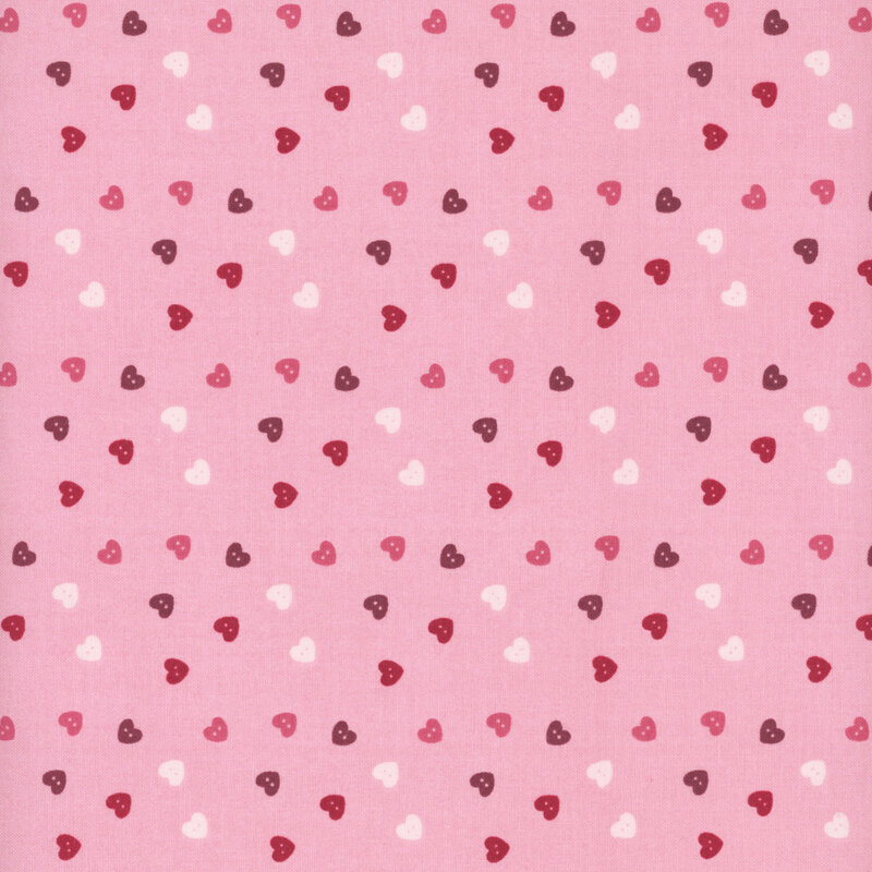 fabric pattern of pink, red, and white hearts scattered all over a light pink background
