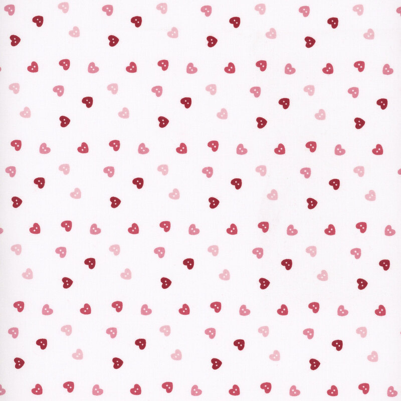 fabric pattern of pink, red, and white hearts scattered all over a white pink background
