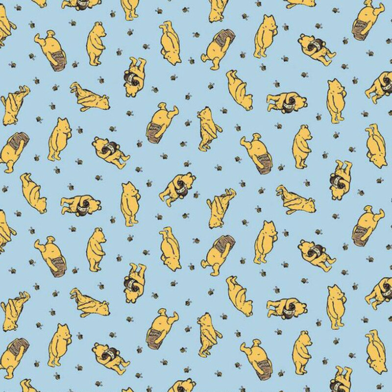 Pattern of playful yellow bears on a light blue fabric, featuring various poses and activities.