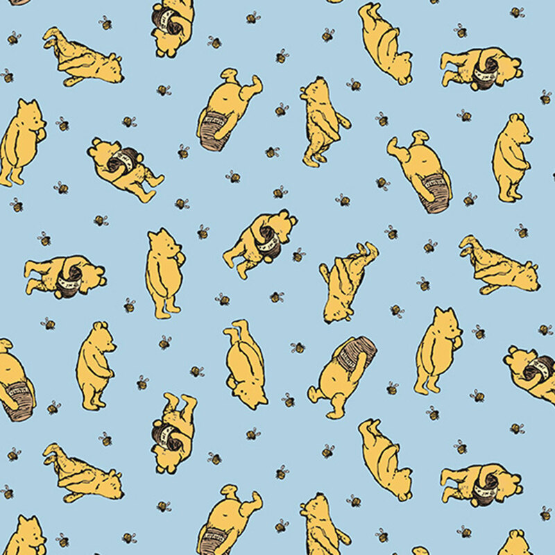 Pattern of playful yellow bears on a light blue fabric, featuring various poses and activities.
