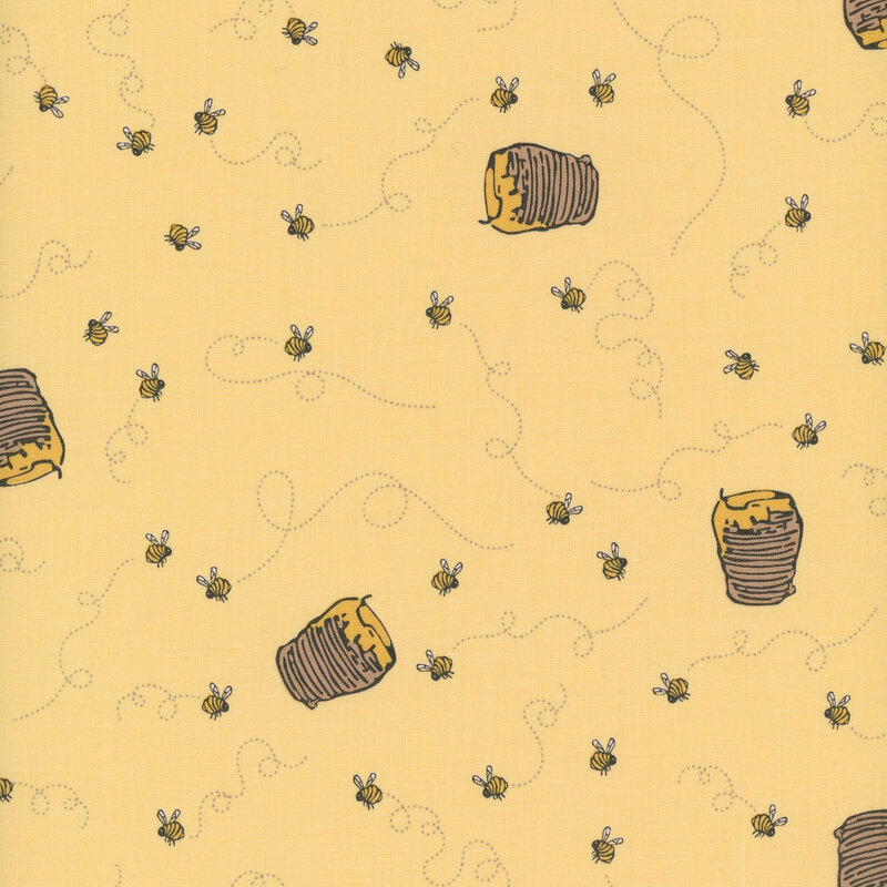 A yellow fabric with honey jars and swirling honey bees.