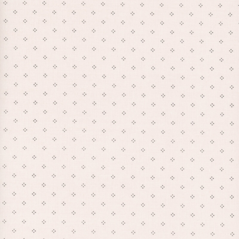 Cream fabric with simple pinprick dotted designs.