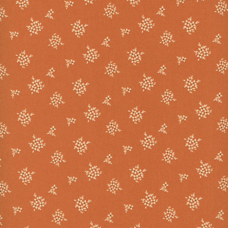 fabric pattern of floral bouquets on a burnt orange background.