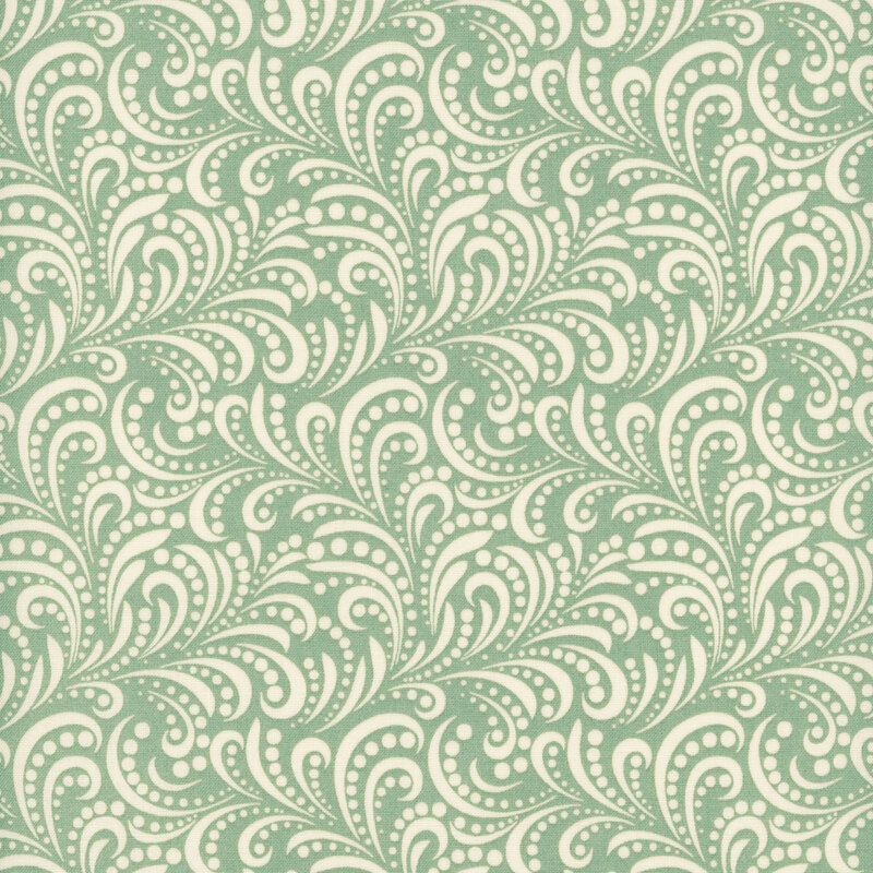 fabric pattern of white swirls on a green background.