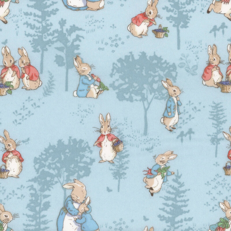 fabric pattern of petter rabbit and friends over a baby blue background with tonal trees