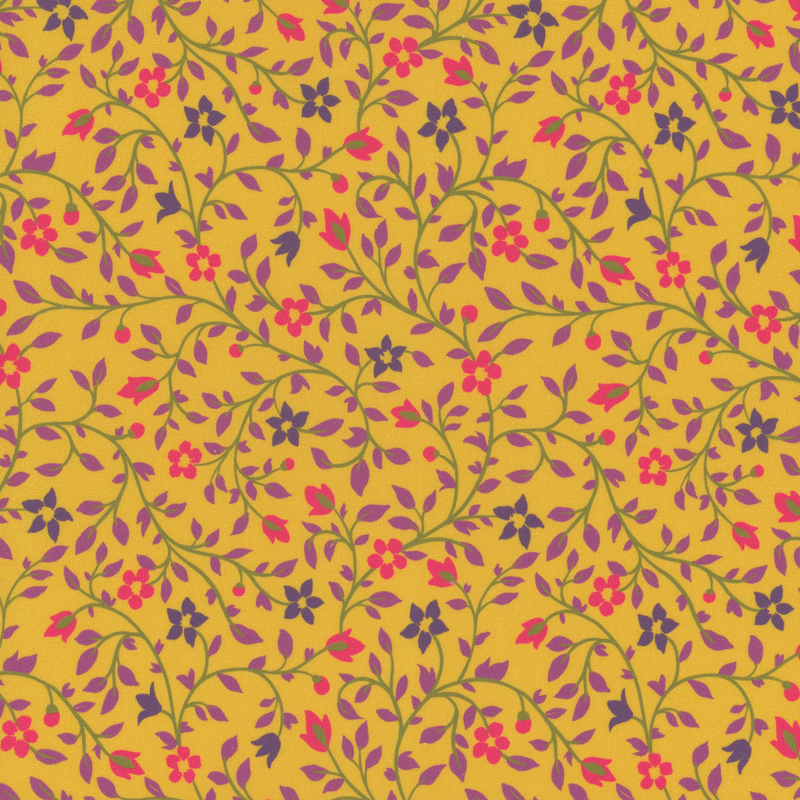 A golden yellow fabric with intricate floral patterns in pink, purple, and green.