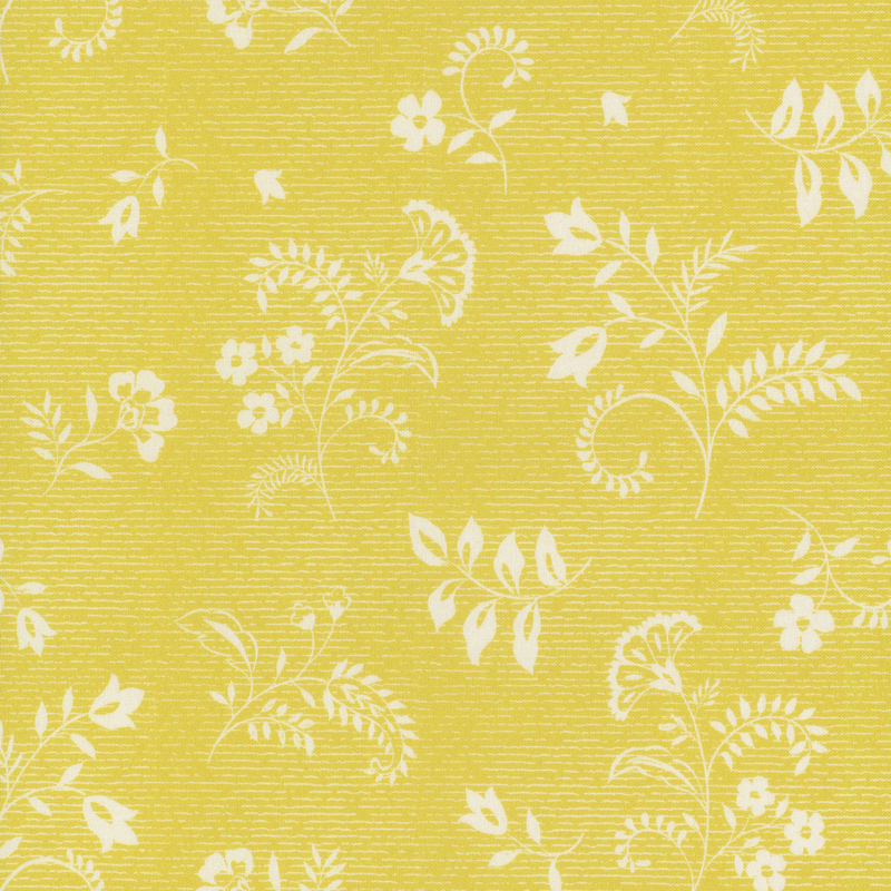 Textured yellow fabric with white floral and leaf designs.