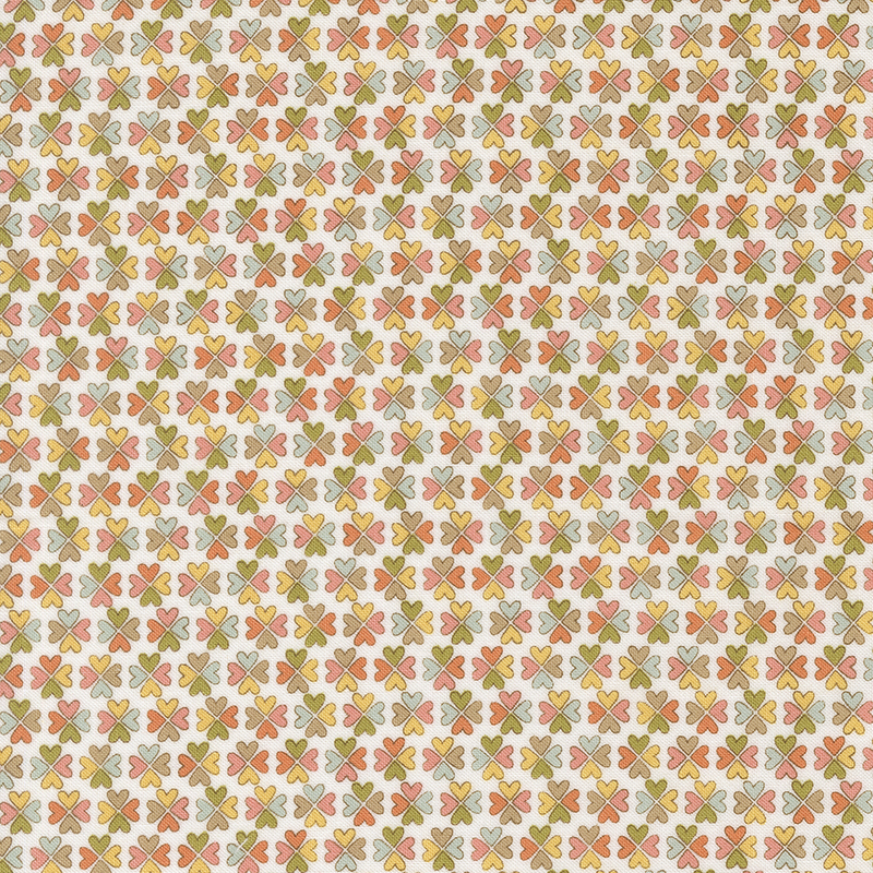 Pattern of small, colorful floral shapes in orange, green, and pink on a cream background.