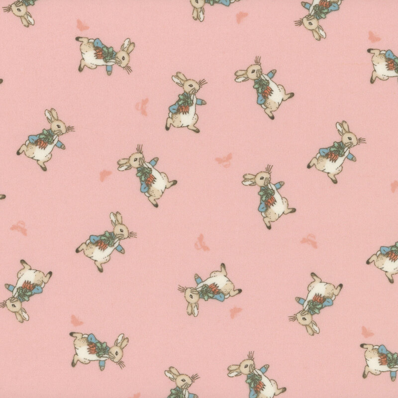 Fabric pattern of petter rabbit in alternating pattern over a coral pink background