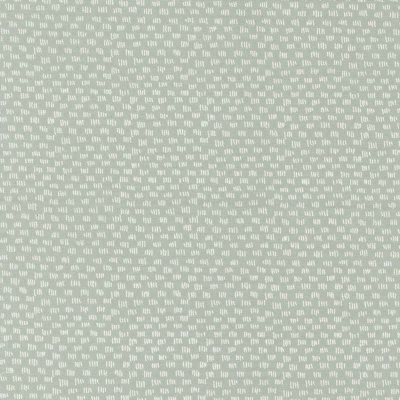 Light aqua fabric featuring a repeating pattern of small white shapes