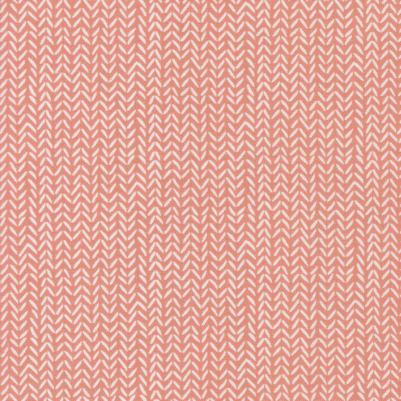 Peach fabric with a repeating herringbone pattern