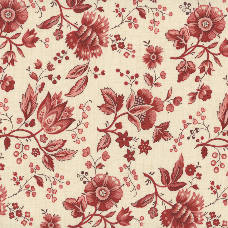 fabric pattern of red florals spread on a cream background