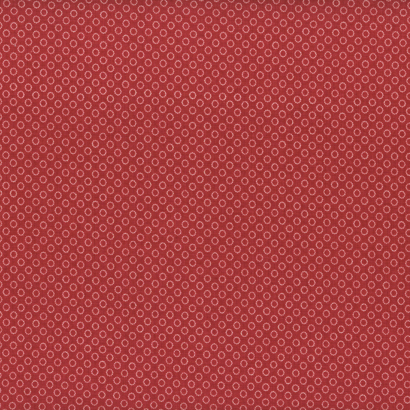 fabric pattern of circles all over a red background