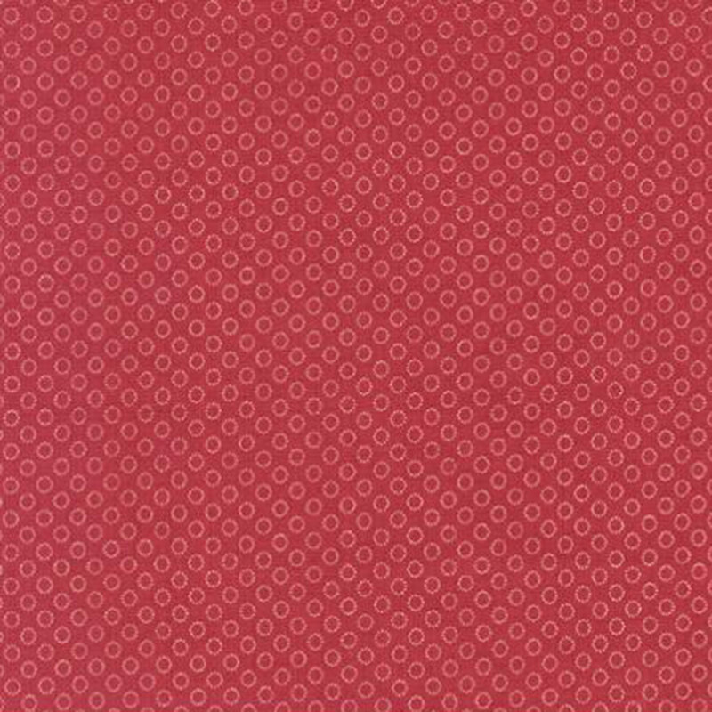 fabric pattern of circles all over a red background