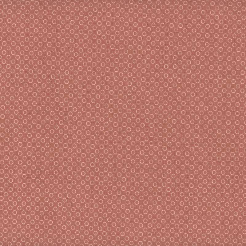 fabric pattern of circles all over a red background