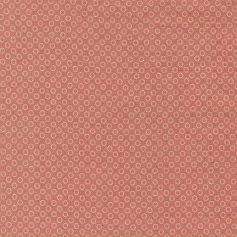 fabric pattern of circles all over a red background