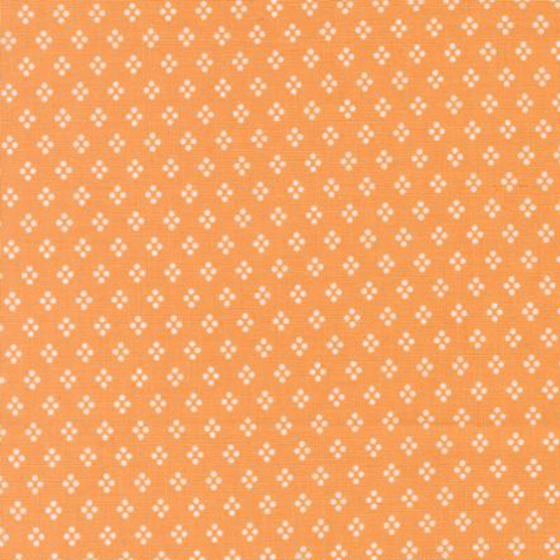 fabric pattern of white motifs all over a orange background